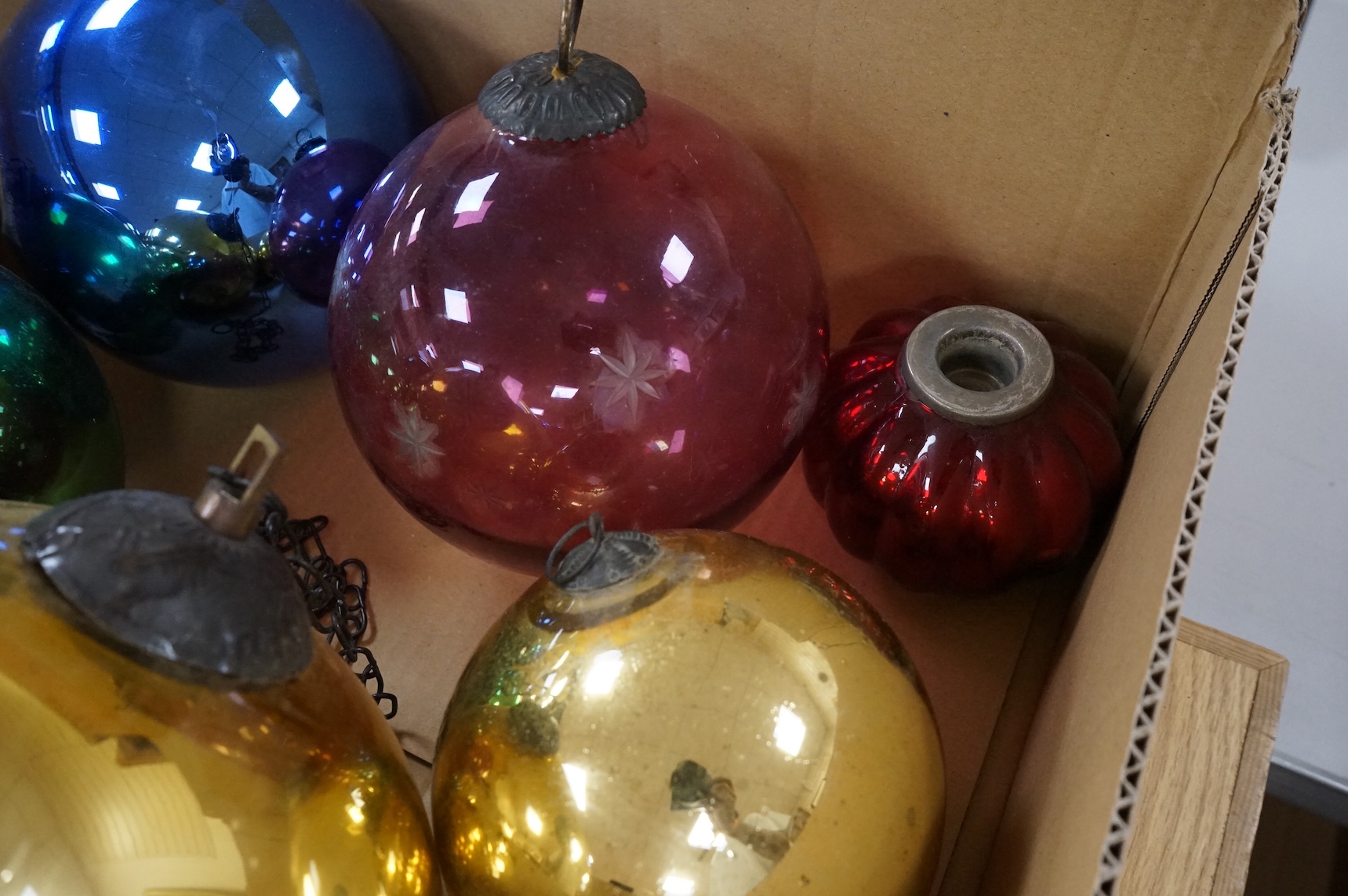 A collection of coloured circular and grape shaped glass witches balls and decorations, largest grape decoration 40cm in length